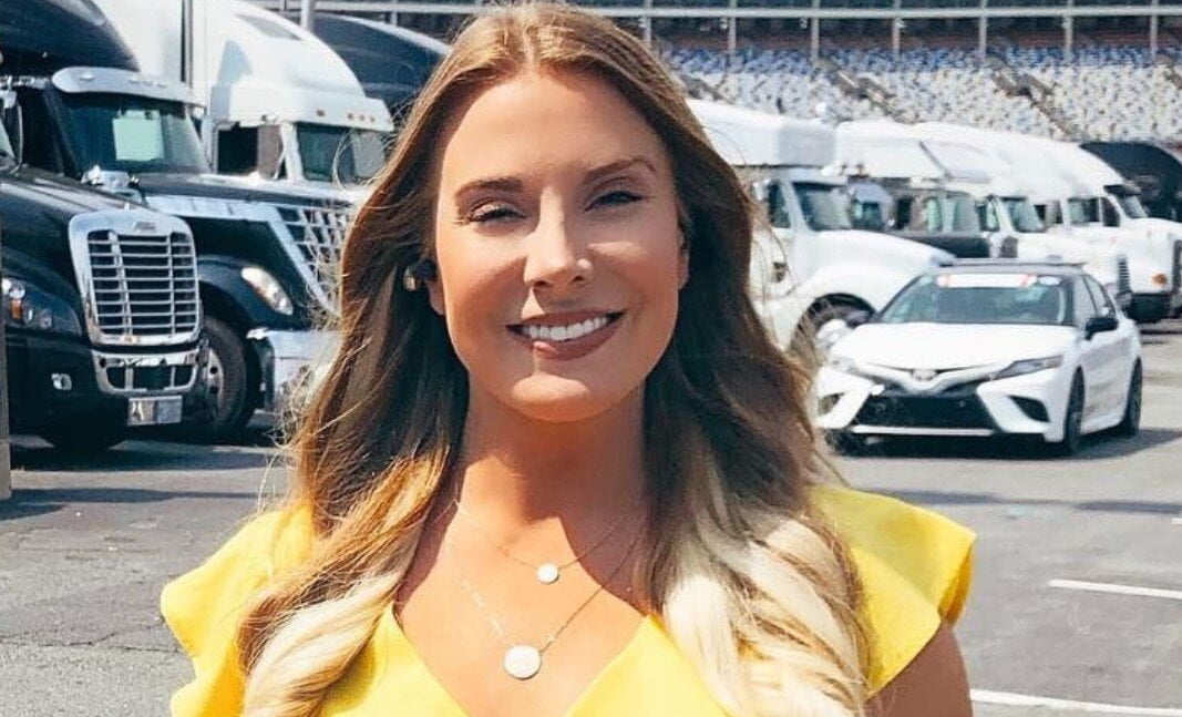 Kaitlyn Vincie smiling and cars seen in the background an open space