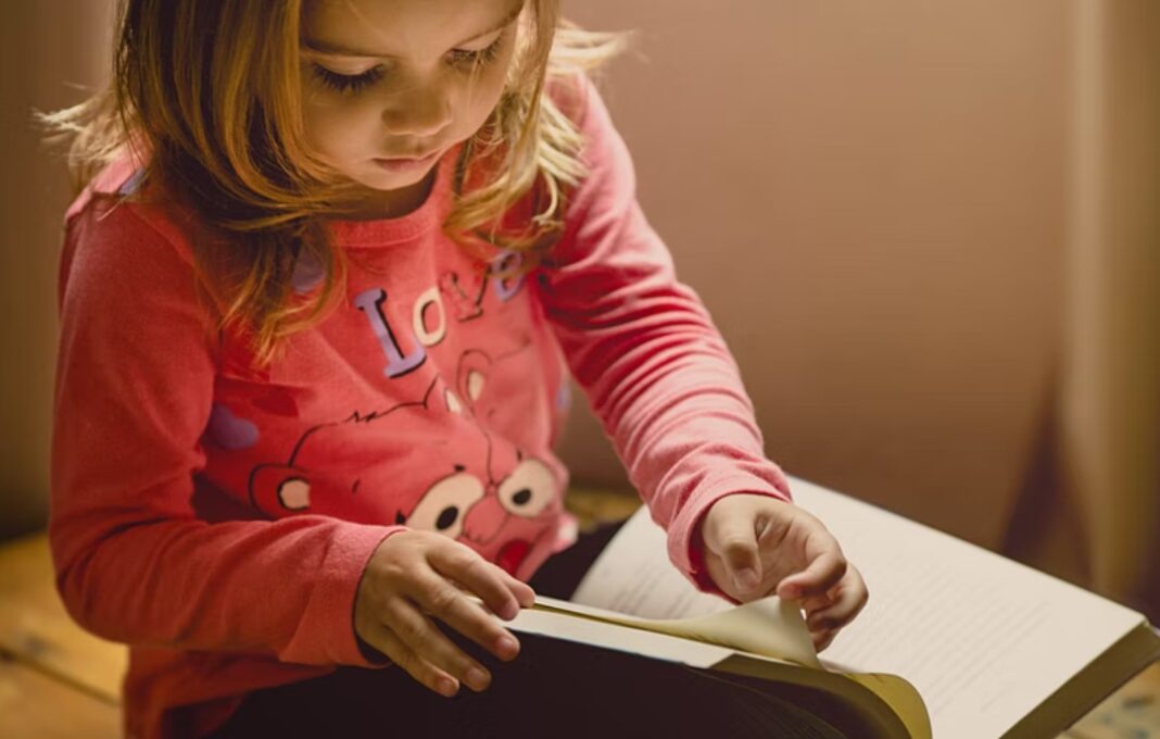 young girl reading a book