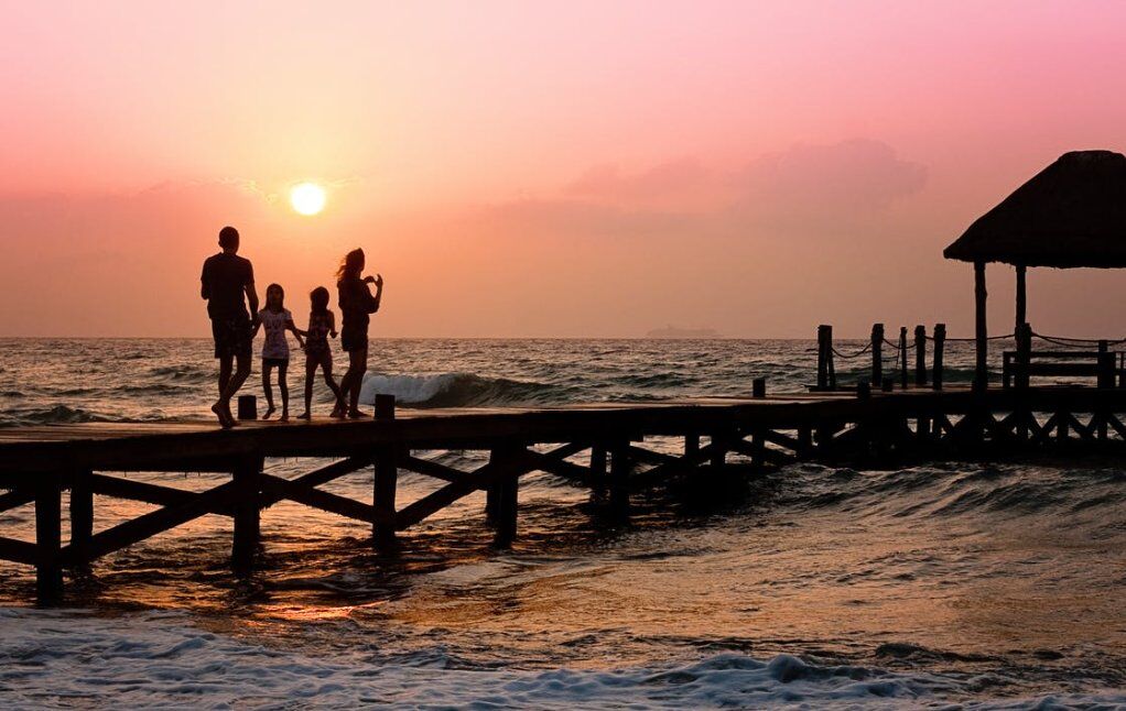 family on the pier during sunrise