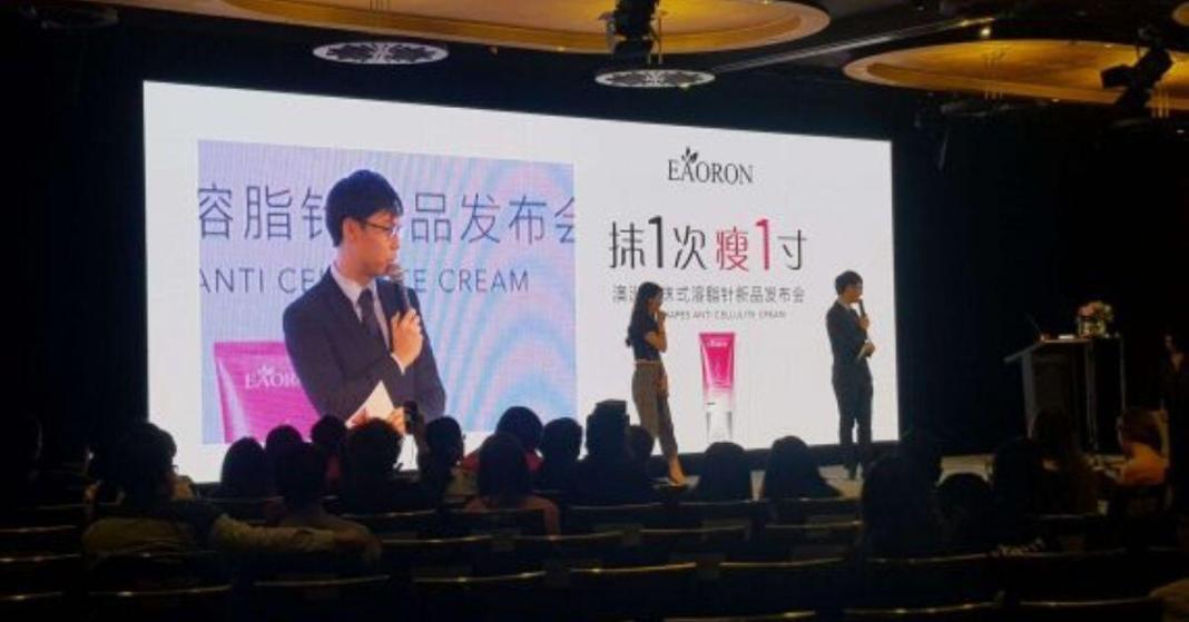 A host hosting conference in from of LED Screen in theater