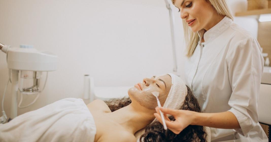 a lady giving head massage to another lady lying on the bed