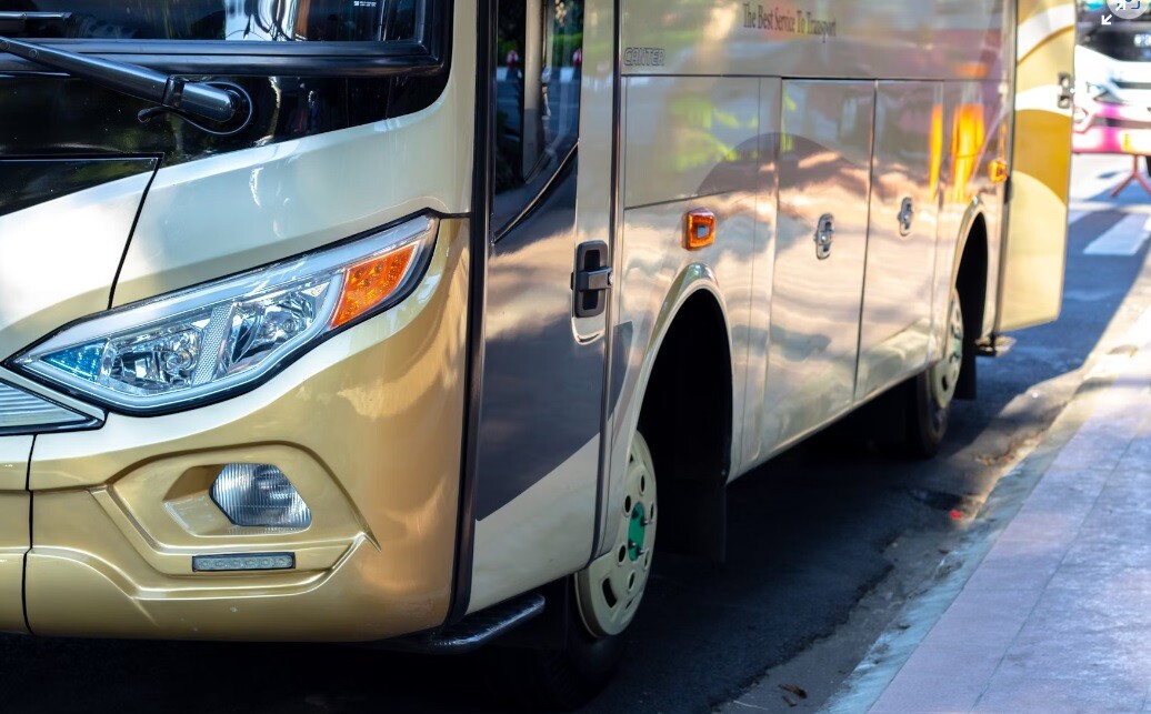 a bus in golden yellow color showing travel luxury