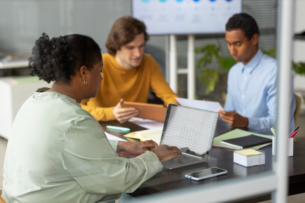 a few people working in an office desk