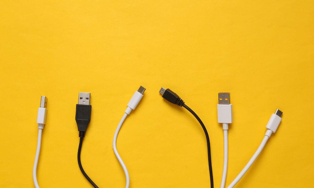 Different USB cables on a pink background