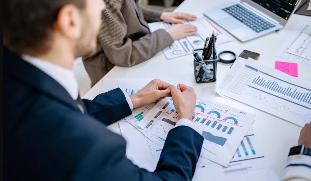 an auditor in blue suit writing important points in a sheet of paper