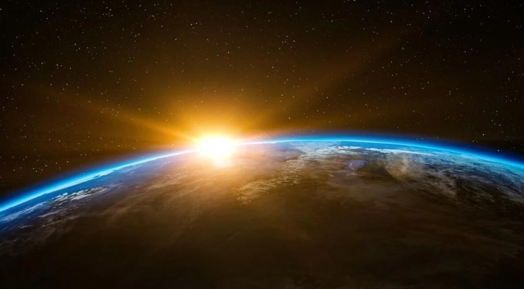 a space view of Earth and Sun intersecting at the edge in space technology
