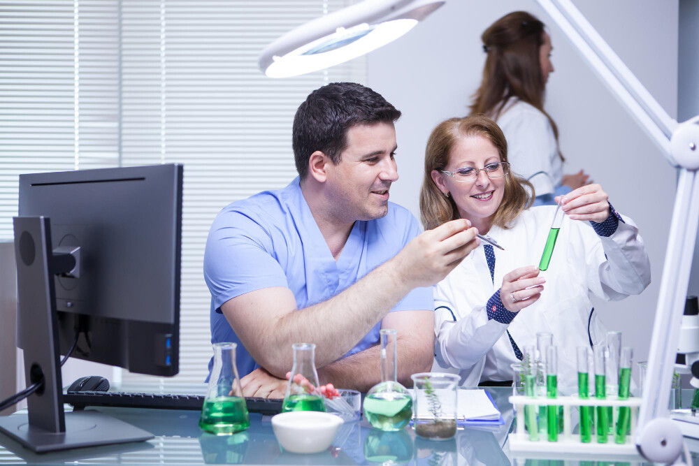 a man and a lady doing science experiments in a lab environment