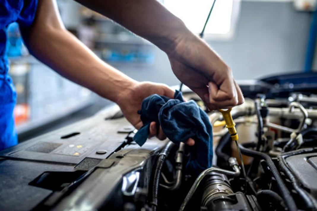 a person making repairing of a mechanical part of a machine
