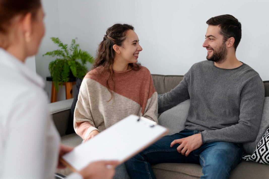 a man and woman discussing each other about their relationships on a sofa