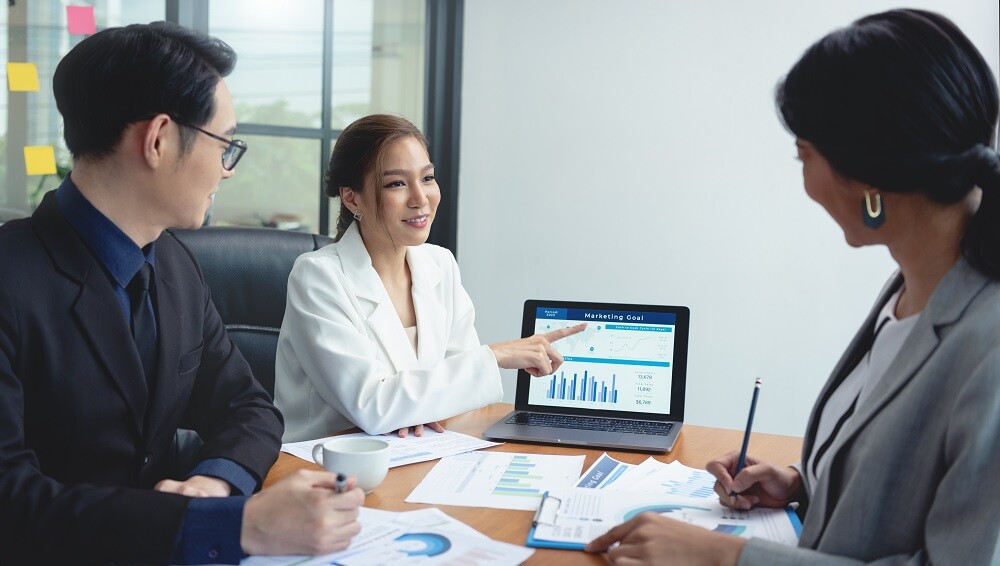 Asian business person meeting about business plan and presenting the stock financial chart