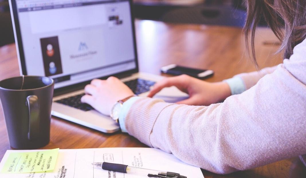 a lady working on a laptop by typing the keyboard for product design