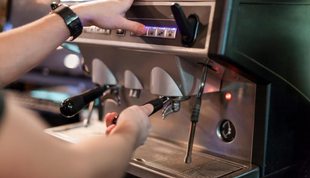 person taking tea or coffee from the soft serve machines