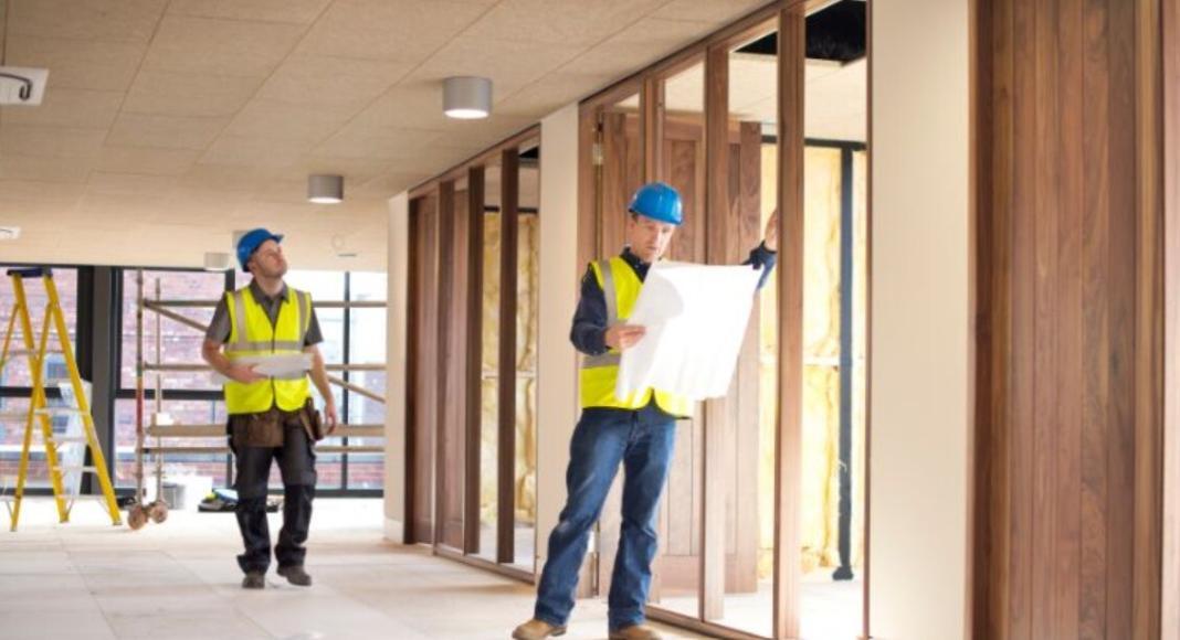 a person inspecting the structure of a building dressed as a civil contractr in a fit out company