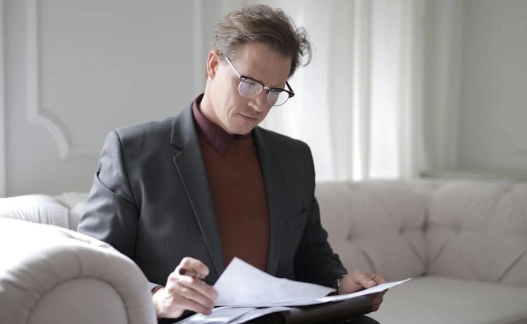 a person seriously reading documents of a legitimate insurance claims