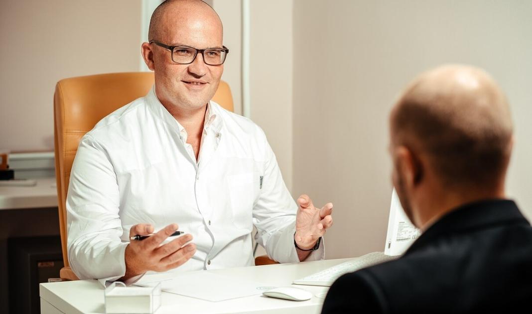 a doctor is discussing with a patient about his diagnosis and treatment