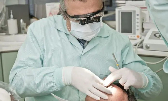 a dentist inspecting the teeth of a patient in a clinic