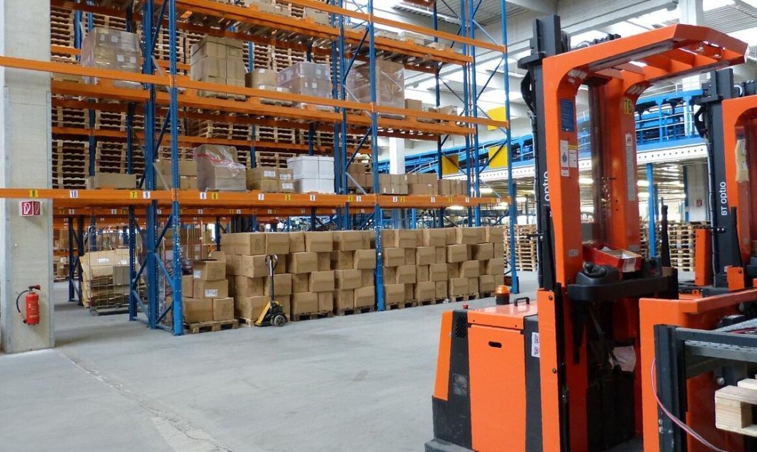 factory inside with racks and forklift machine