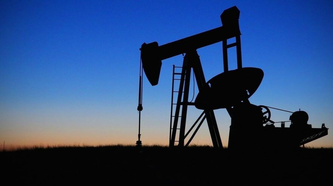 pump jack for digging oil from the ground with blue shade background