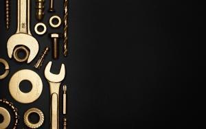 spanners, screws and tools used in engineering with dark background