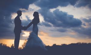 wedding couples in dawn with clouds behind them