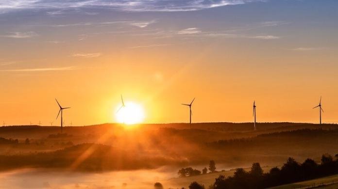 wind mills in the farm on a bright sunrise day