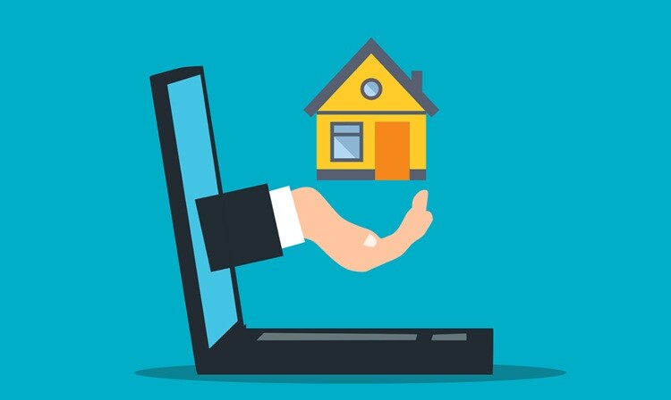a laptop and a house shown projecting near the screen