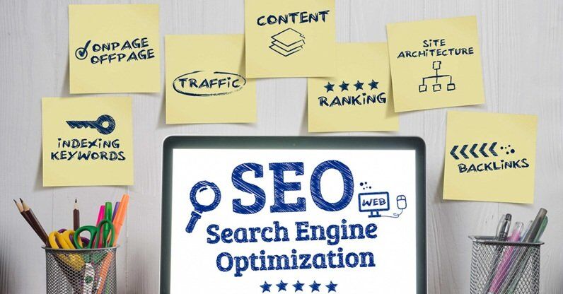 SEO displayed on a laptop screen with sticky notes showing traffic, speed, content