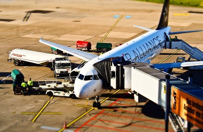 airplane with the ground equipment near it in the activity of maintenance