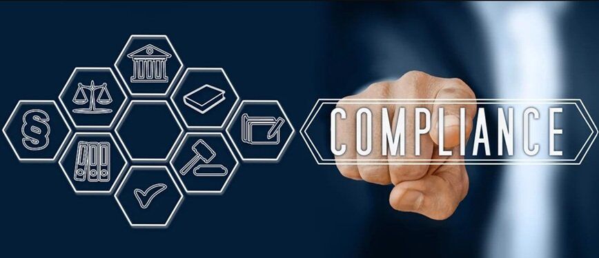wrist of a a man hitting on the word compliance with a few icons beside