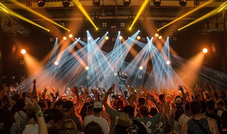 a musical event with a large number of audiences watching a stage performance