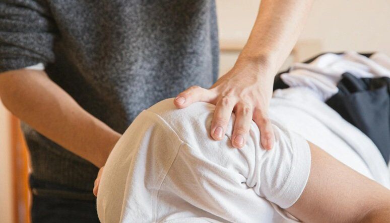 a person treating another person on his spinal cord lying on a bed