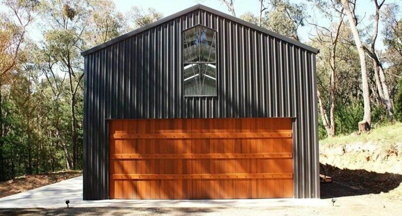 storage sheds in a green land space with trees in the background