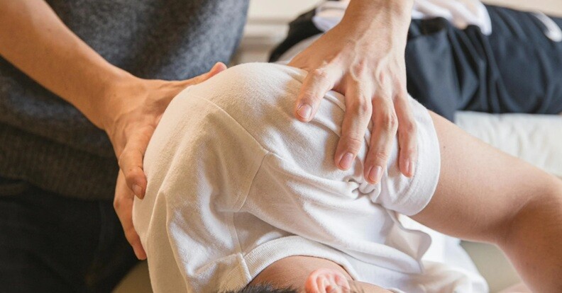 a patient being diagnosed on Chiropractic Treatments