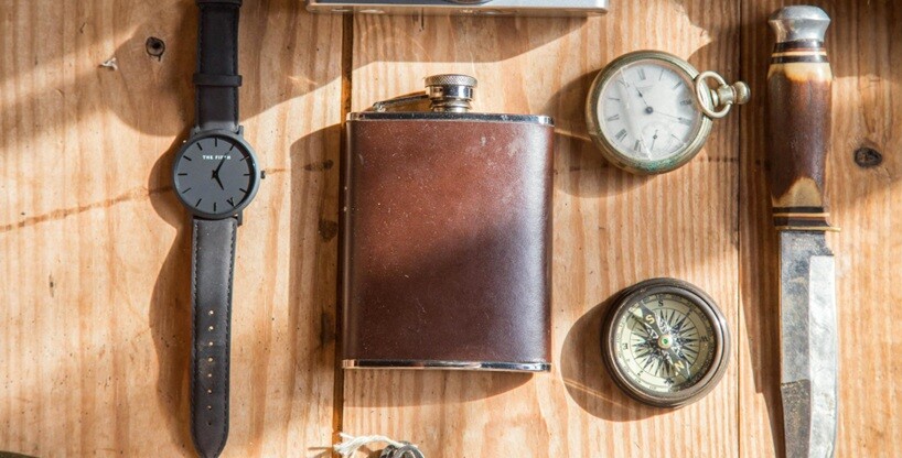 old collectibles placed on a table like watch, knife, bottle