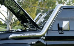 a black jeep with steel snorkel with open bonnet