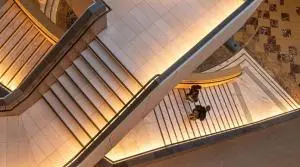an innovative staircase with lights and two people walking down the stairs