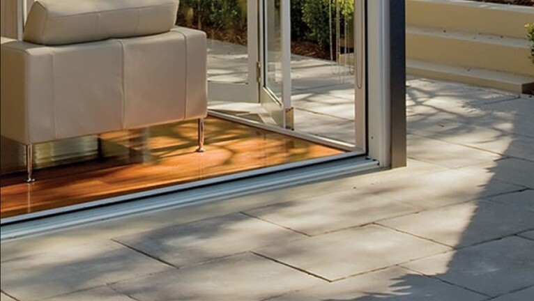 a sofa placed near the patio which is neat and clean