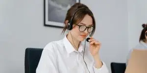 a lady receptionist talking over phone just answering customer queries