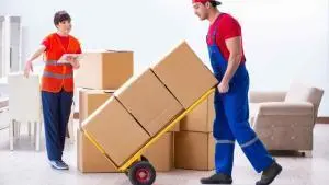 a person moving cartons using a movable machine from the house