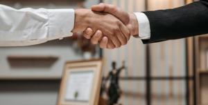 a lawyer shaking hands with another person