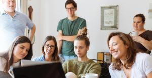 a group of people looking a laptop on AI applications