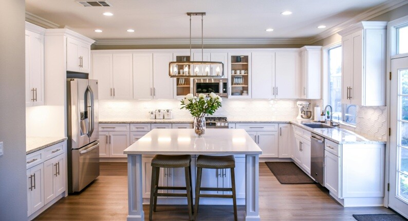 a modern kitchen cabinet with dining table and chairs