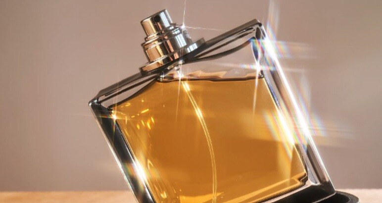 costly scent shining in golden liquid placed on a table