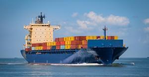 a ship sailing n the sea with cargo shipments