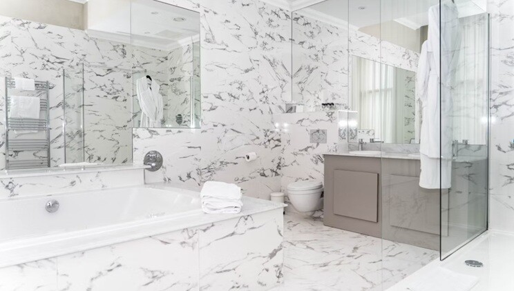 a bathroom with tub, basin, towels and tabs