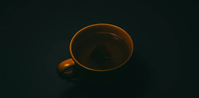 coffee a coffee cup with filled coffee in a black background