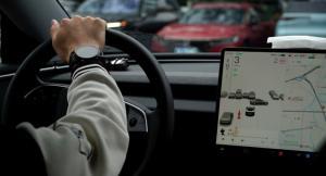 a person hand holding a steering of a car with GPS inside