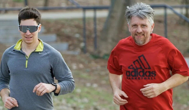 men running two persons running on the pathway together to stay fit