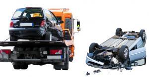 an accident scene where a car is taken on a truck and another car lying upside down