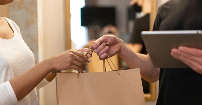 businesses a salesman handing over a shopping cart to a lady customer on a store